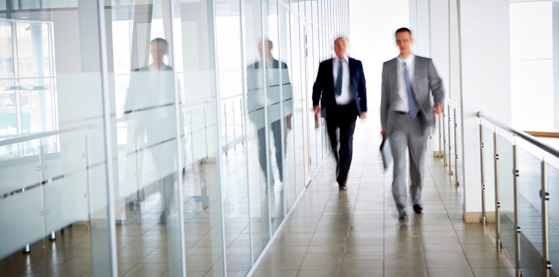 Business people walking in the office corridor